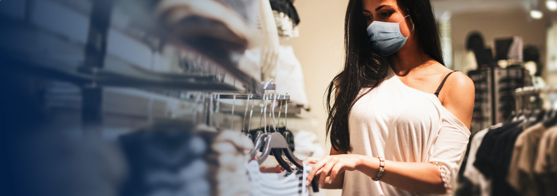 woman in a clothing store wearing a face mask