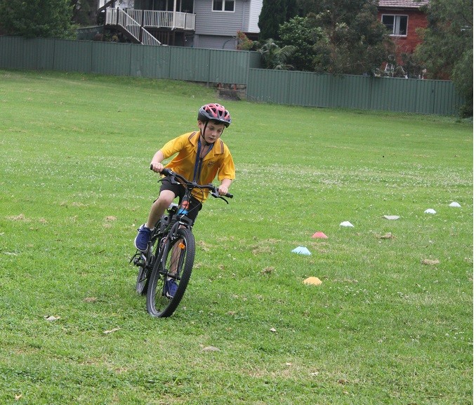 Student riding bicycle.