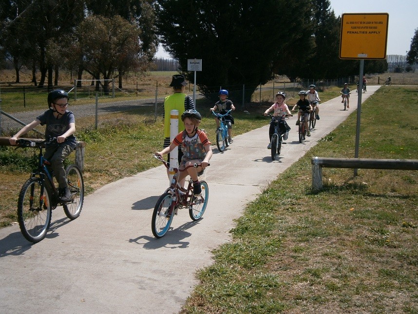 Children riding bicycles on a bike track.