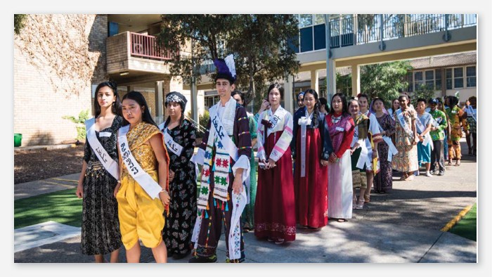 A parade of students wearing different cultural outfits.