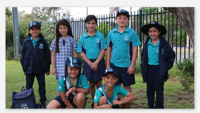 A group photo of seven students modelling the new Warwick Farm school uniforms.