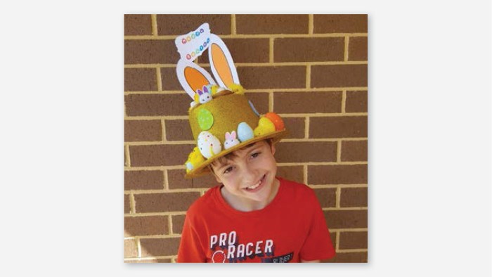 Photograph of a student wearing a decorated Easter hat