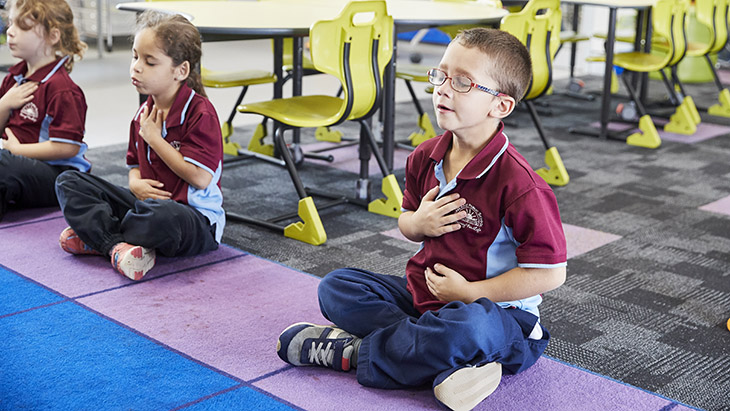 Student focusing on wellness breathing.