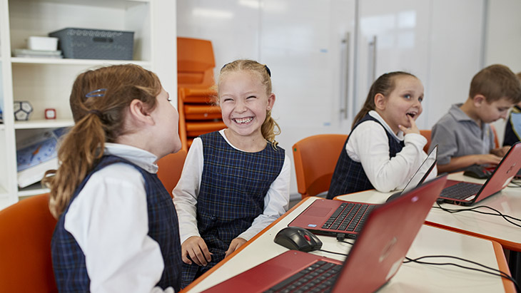 Students talking in the classroom.