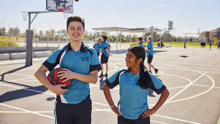 Students playing sport in the school grounds.