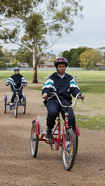 High school student riding on a bike.