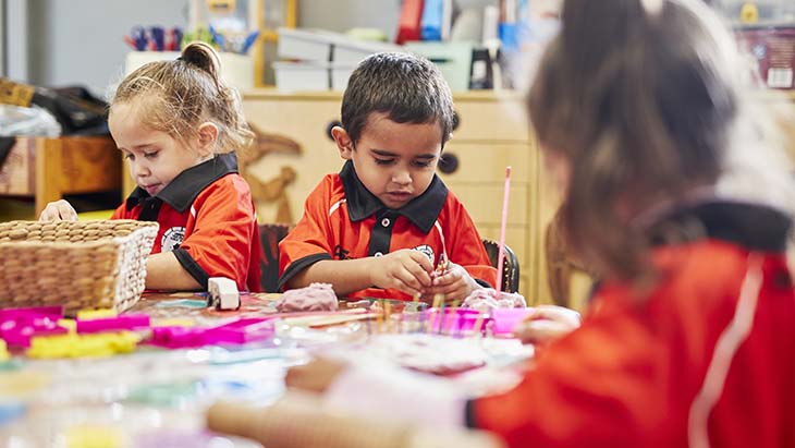 Students playing with playdough in the classroom.