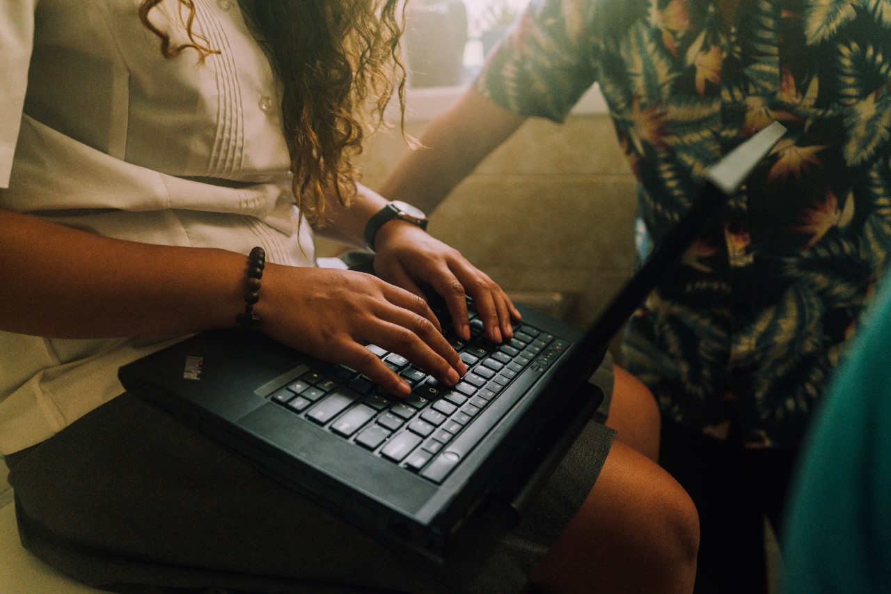 Student typing on keyboard.