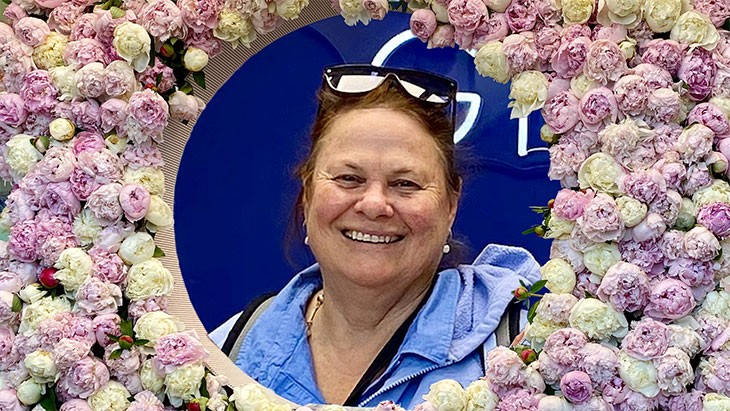 A photo showing Julie Munro smiling face framed by a circle of flowers.