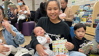 Donna Vienkgham holding her baby, Taika. Her two-year-old son, Theodore, is sitting to her left.