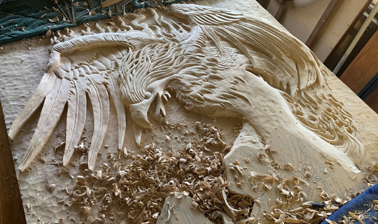 A wooden carving of a phoenix