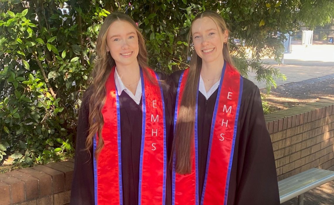 Two girls wearing red and blue sashes.