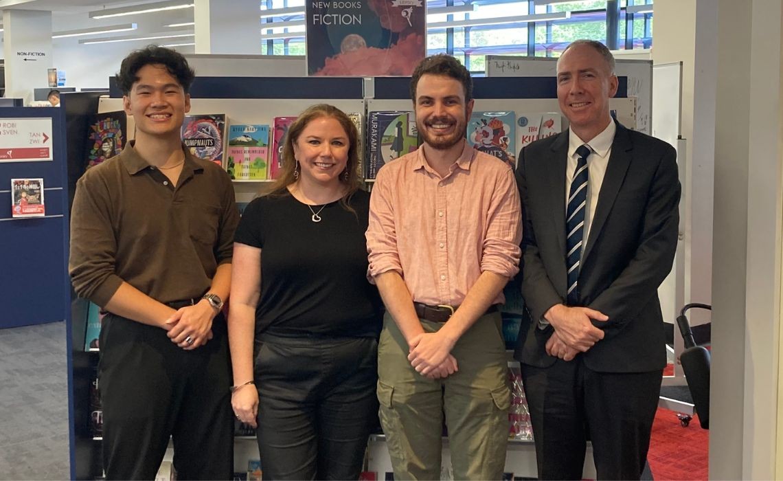 A group of people in a library.