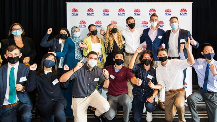 A group of students wearing masks with the Education Minister