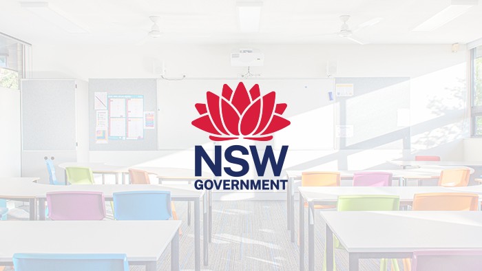 A row of desks with the government waratah logo