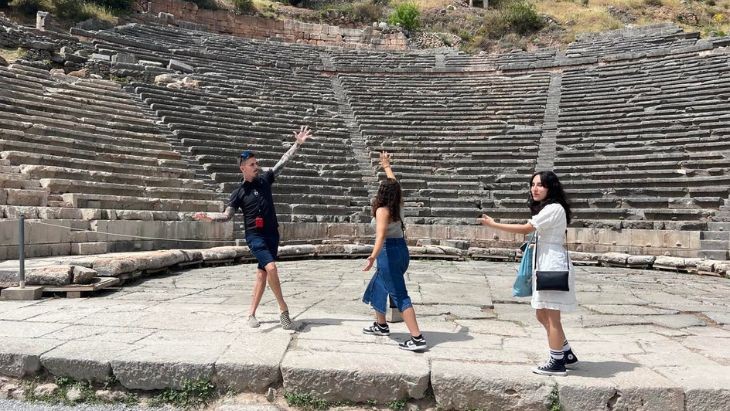 Students dancing in an ancient amphitheatre.