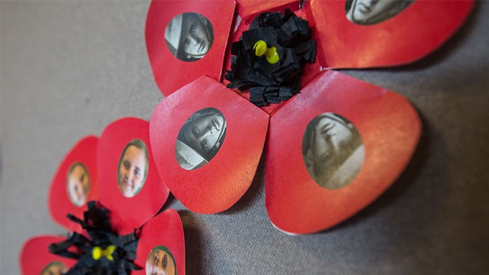 Handmade poppies with faces in the petals.