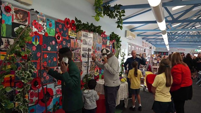 Parents look over an Anzac display at a school.