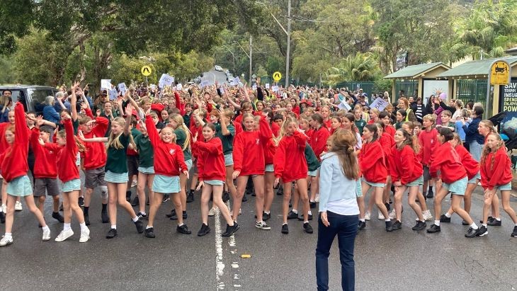 Students dancing in the street.