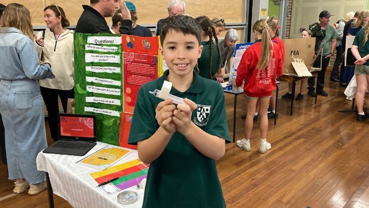 A boy holding a syringe.