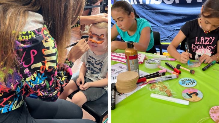 A child having their face painted and two girls colouring in.