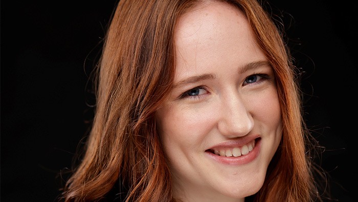 A headshot of a redheaded young woman