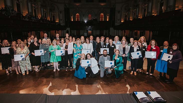 People in a group photo holding certificates.