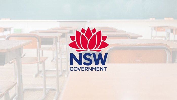 A photo of a row of desks with the government logo superimposed on the image