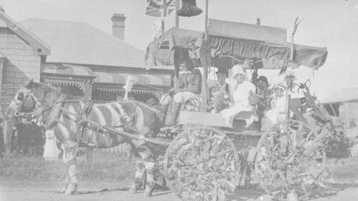 Students sitting on a horse-drawn wagon.