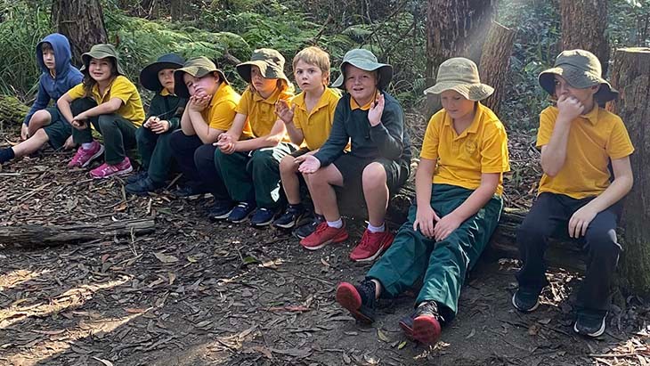 Students from Eungai Public School sitting on a log.