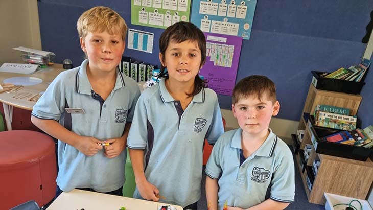 Three students from Smithtown Public School posing for a photograph.