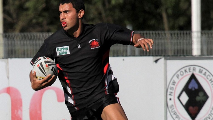 A rugby league player with ball.