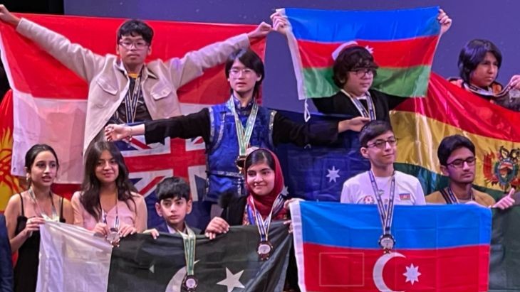 Students holding flags from across the globe.