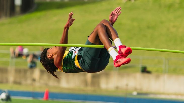 A boy doing high jump.