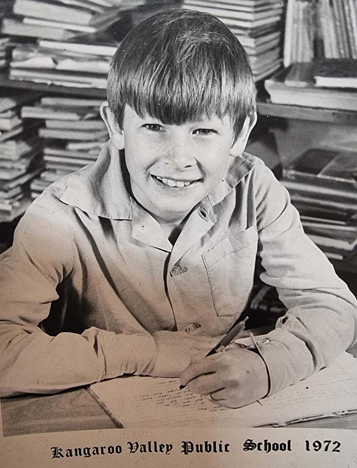 A boy writing at a desk.