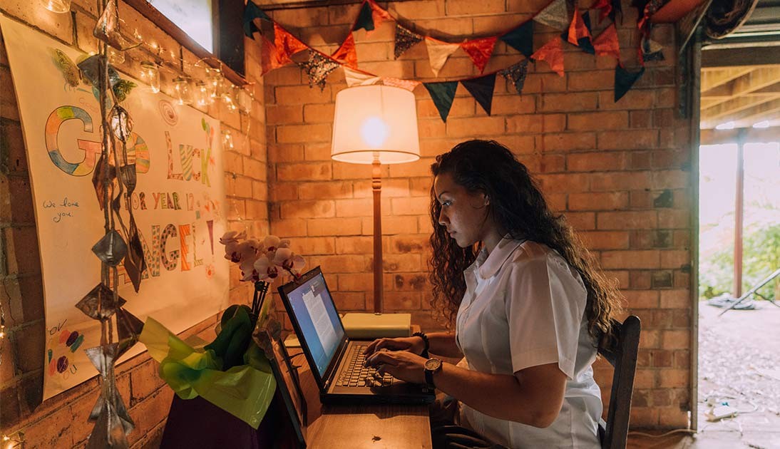 Year 12 student studying at her computer at a desk at home