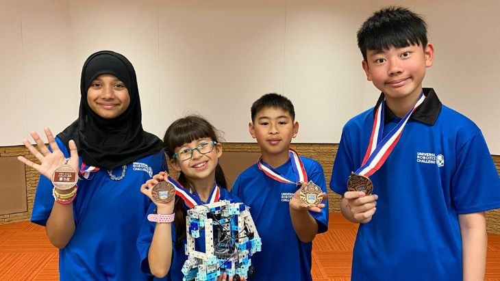 Students holding medals.