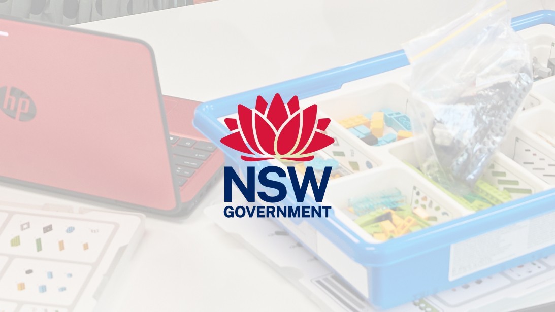 The NSW Government logo overlaying a photo of a laptop and folder on a desk.