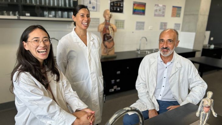 Three teachers in lab coats.