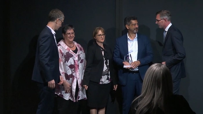 A group of people receiving an award