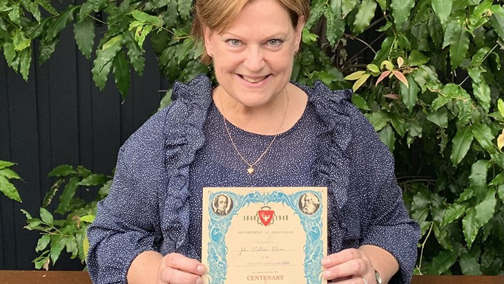 Trudy Bates holding a certificate.