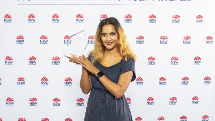 A woman holding an award