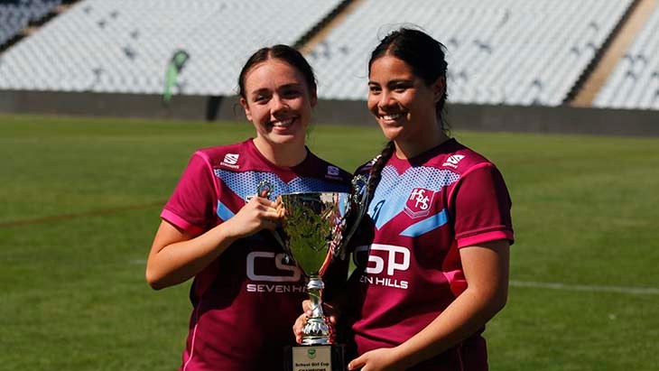 Two students holding a trophy.