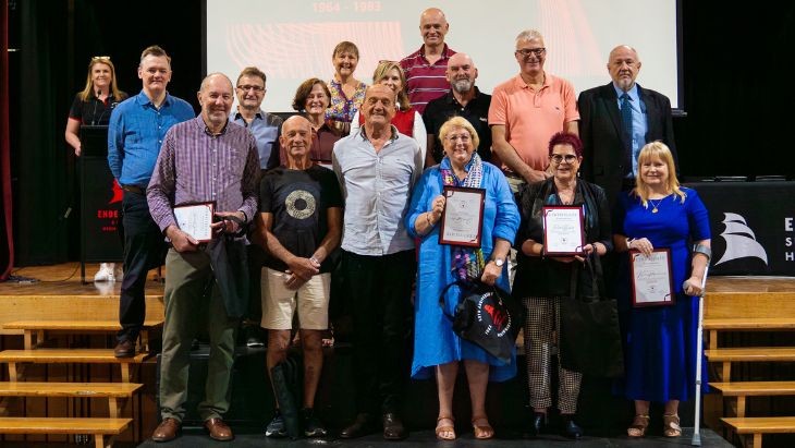 A group of people holding certificates.