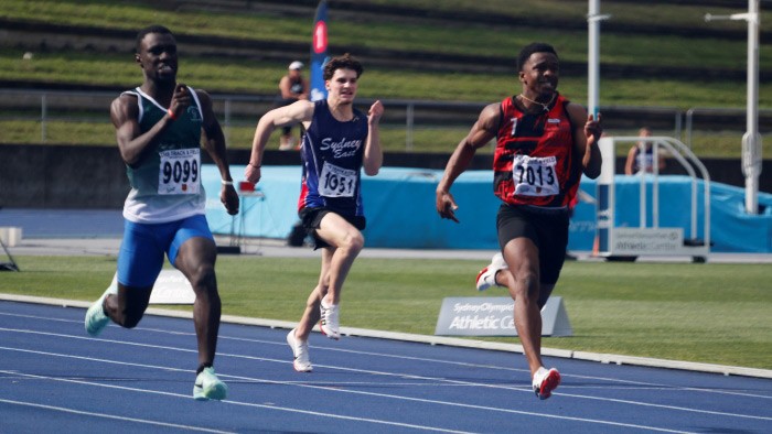 Three young men in a sprint race