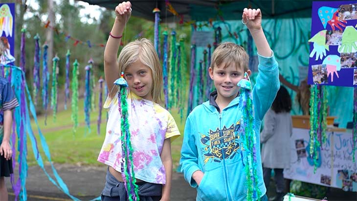 Students holding coloured streamers.