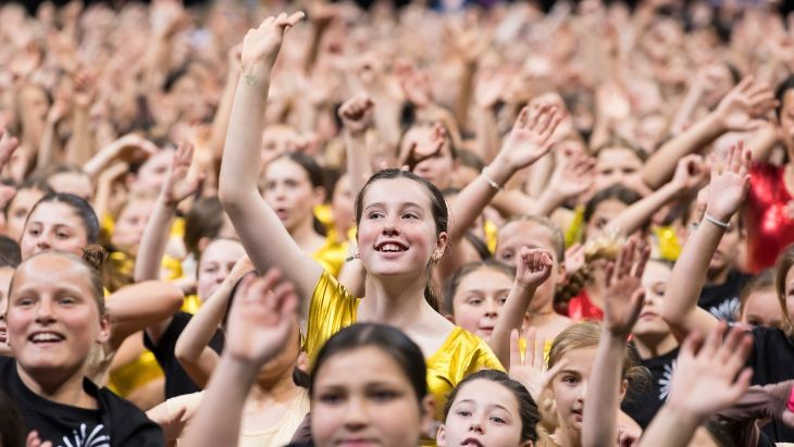 Students with their hands in the air.