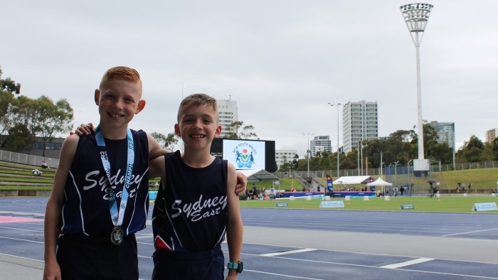 Two boy athletes smiling at the State Primary School athletic championships