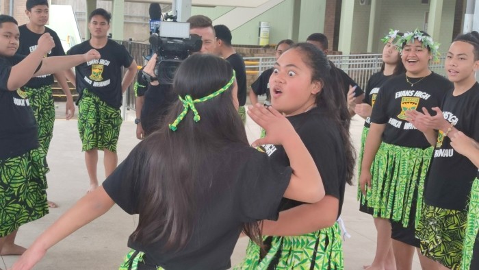 A group of islander girls and boys prepare to perform the haka