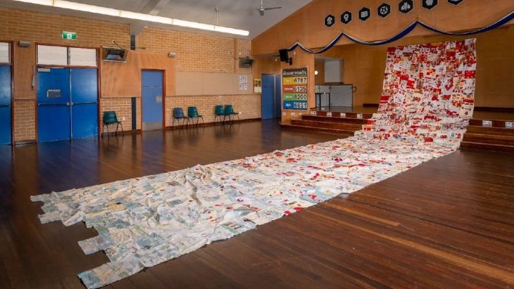 A giant quilt in a hall.